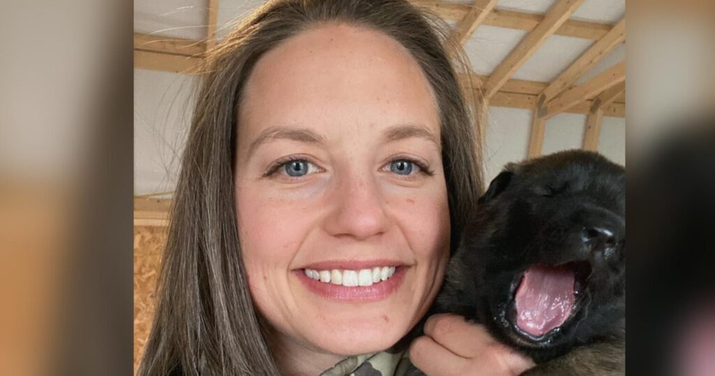 owner cuddling his dog